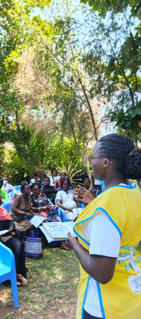 A hospital educator teaching pregnant mothers outdoors during an MCH session